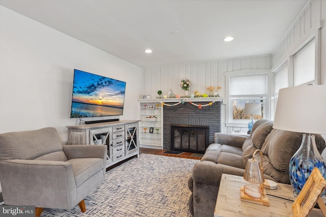 living area featuring a fireplace, wood finished floors, and recessed lighting