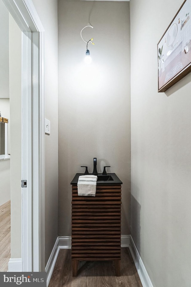 bathroom with baseboards and wood finished floors