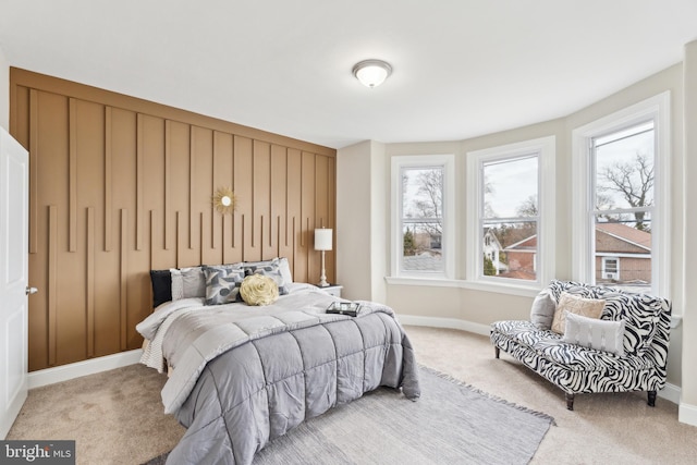 carpeted bedroom with multiple windows and baseboards