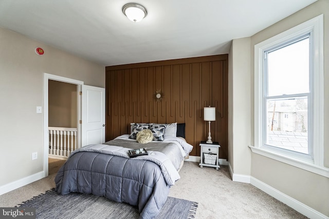 bedroom with light carpet and baseboards