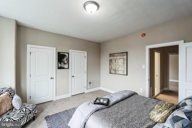 bedroom featuring carpet, visible vents, and baseboards