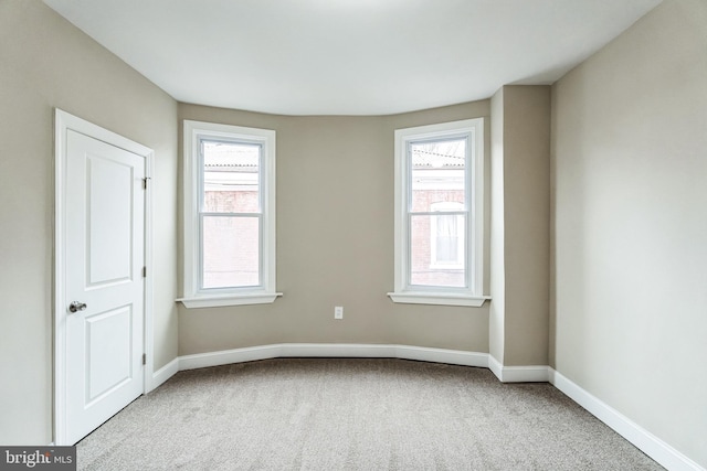 unfurnished room featuring baseboards and carpet flooring