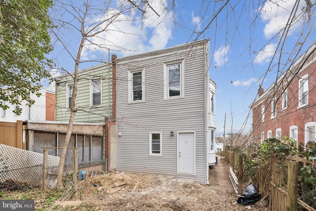 back of house featuring fence