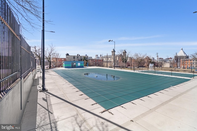 view of pool featuring fence