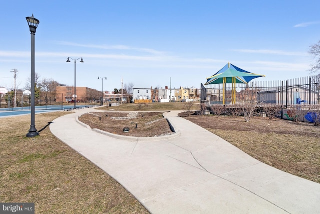 view of home's community featuring fence