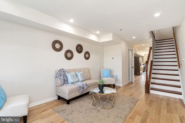 living room featuring recessed lighting, stairway, visible vents, and light wood-style floors