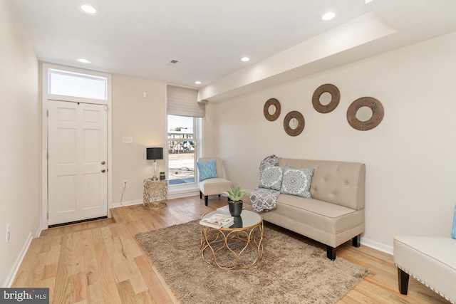 sitting room featuring light wood finished floors, recessed lighting, and baseboards