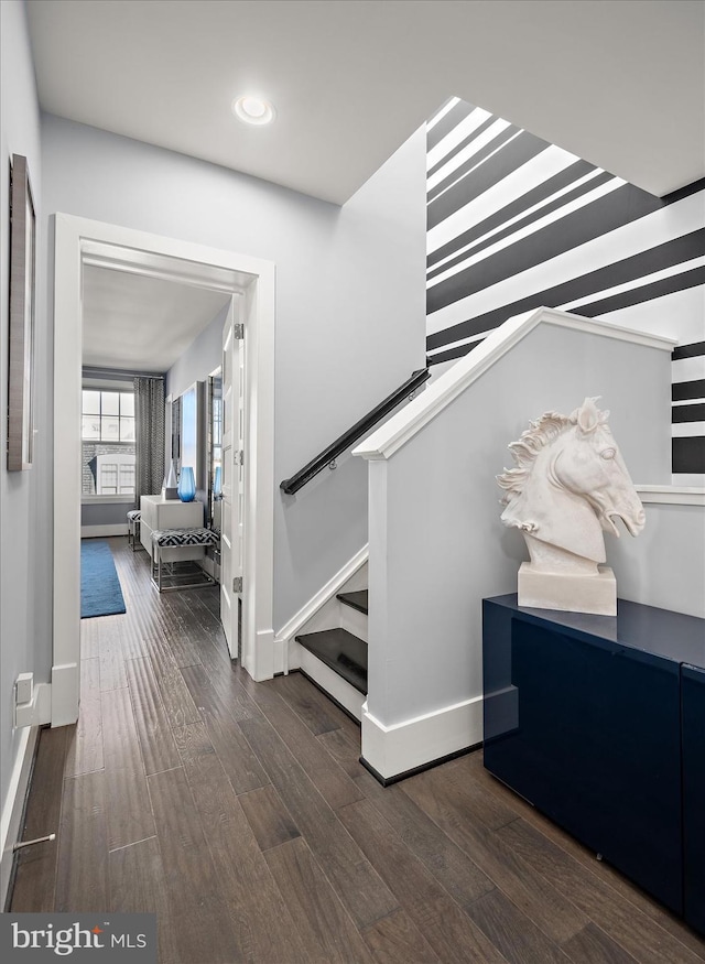 stairway featuring recessed lighting, baseboards, and wood finished floors