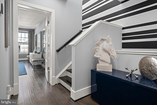 interior space featuring stairs, baseboards, and dark wood-style flooring