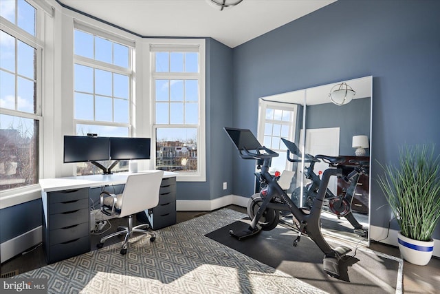 office space featuring baseboards and wood finished floors