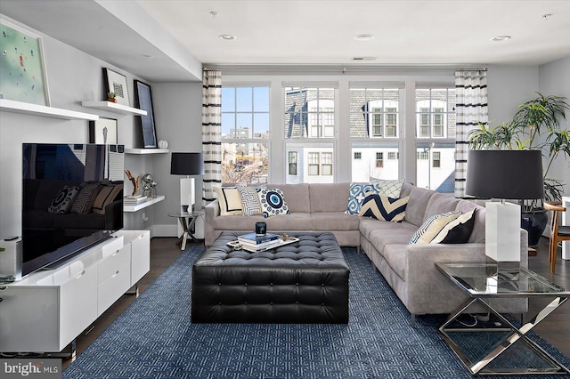 living area with wood finished floors, visible vents, and recessed lighting