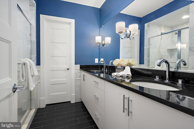 full bathroom with a stall shower, a sink, and double vanity