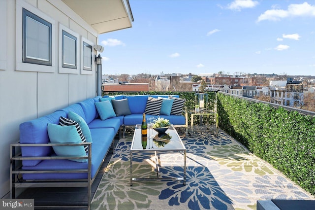 balcony featuring an outdoor living space and a city view