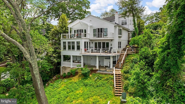 141 Boone Trl, Severna Park, MD 21146 - back of house featuring stairs, a balcony, a chimney, and a wooden deck