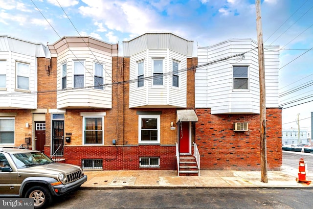 townhome / multi-family property with brick siding and entry steps