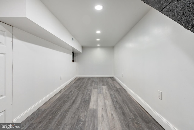 finished basement featuring visible vents, recessed lighting, wood finished floors, and baseboards