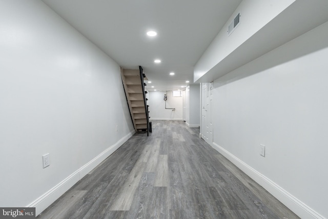 hallway with visible vents, recessed lighting, wood finished floors, and baseboards