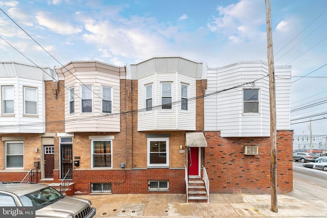 multi unit property featuring entry steps and brick siding