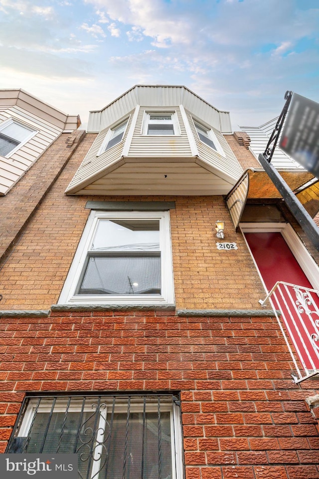 exterior space with brick siding