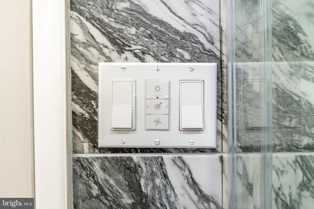 details featuring a marble finish shower