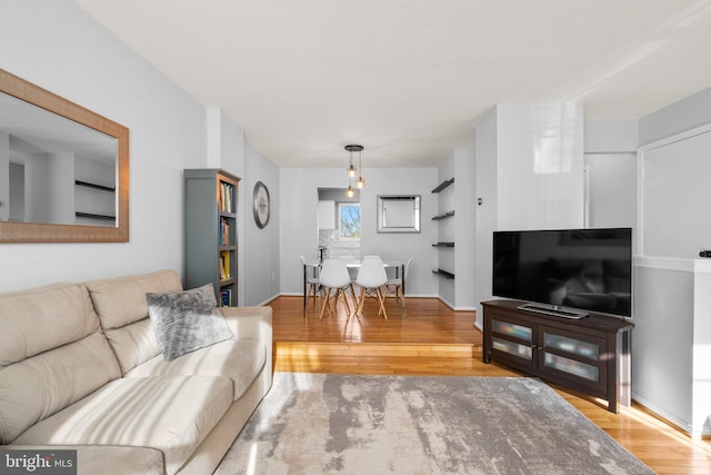 living area with wood finished floors and baseboards