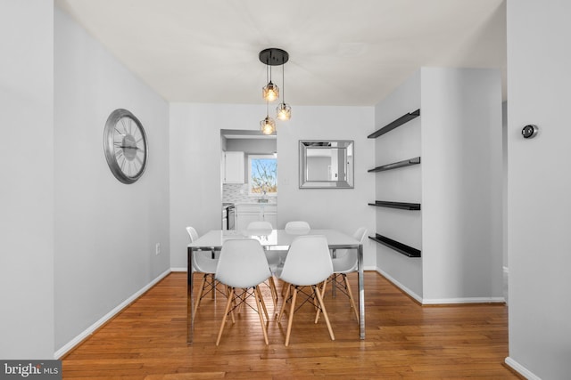 dining room with baseboards and wood-type flooring