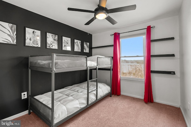 carpeted bedroom featuring a ceiling fan and baseboards