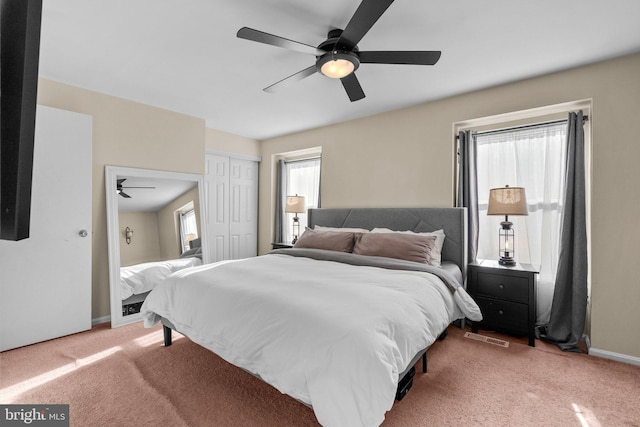 bedroom featuring carpet flooring, multiple windows, and baseboards