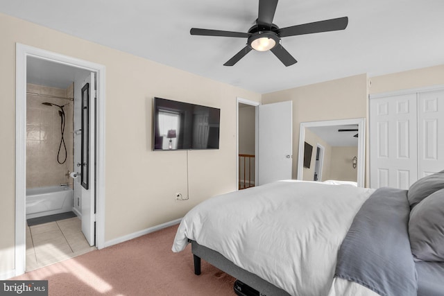 bedroom with light tile patterned floors, a ceiling fan, baseboards, a closet, and light colored carpet