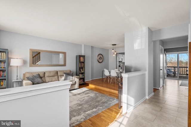 living area featuring baseboards and wood finished floors