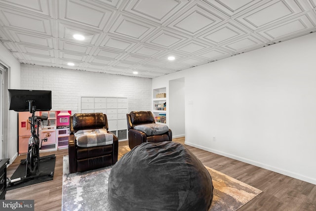 living area featuring light wood-style flooring, baseboards, and an ornate ceiling