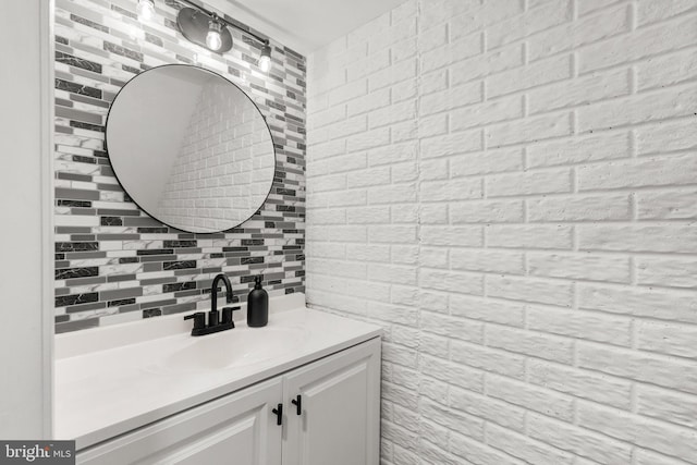 bathroom with tasteful backsplash and vanity