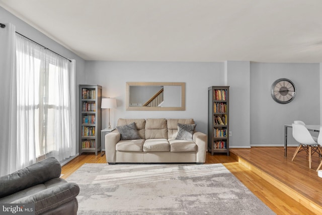 living room with baseboards and wood finished floors