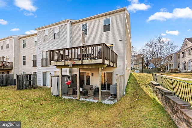 back of house featuring central air condition unit, a patio, a residential view, and a yard