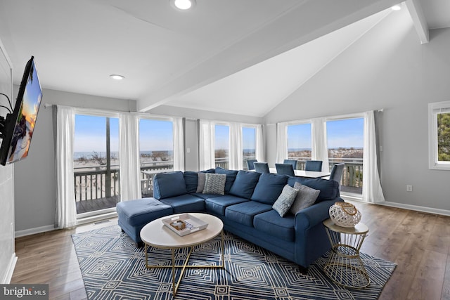 living room with light wood-style floors, recessed lighting, beam ceiling, and baseboards