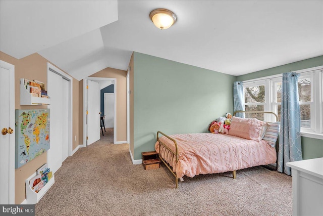 bedroom with carpet, baseboards, and vaulted ceiling