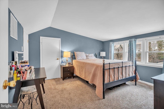 bedroom featuring carpet floors, baseboards, and vaulted ceiling