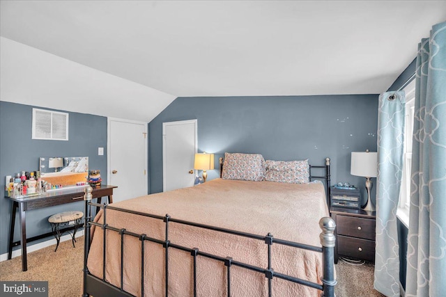 bedroom with lofted ceiling, baseboards, light carpet, and visible vents