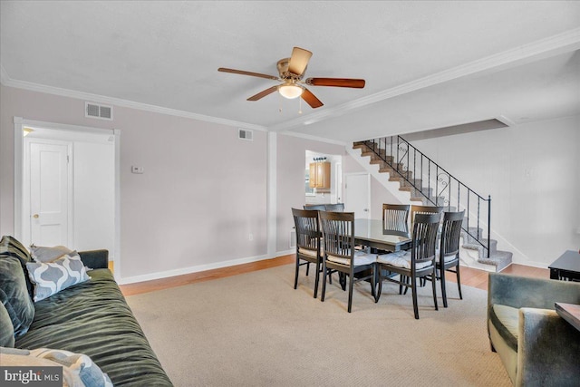 dining area with baseboards, stairway, visible vents, and crown molding