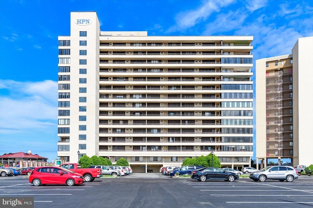 view of building exterior with uncovered parking