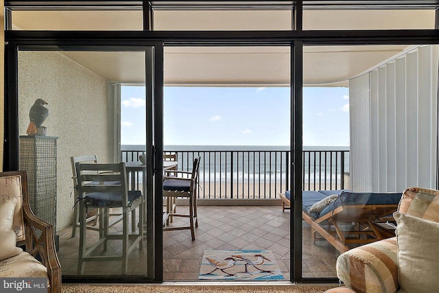 sunroom / solarium featuring a wealth of natural light and a water view