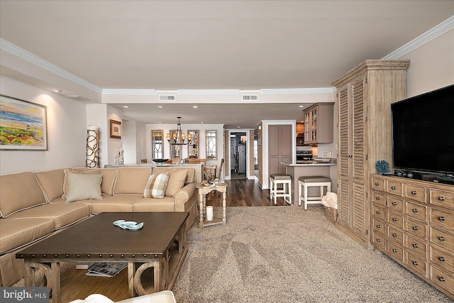 living room featuring recessed lighting, visible vents, an inviting chandelier, and crown molding