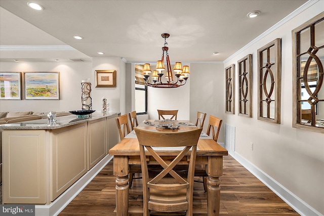 dining room with dark wood finished floors and ornamental molding