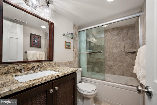 bathroom featuring enclosed tub / shower combo, visible vents, toilet, and vanity