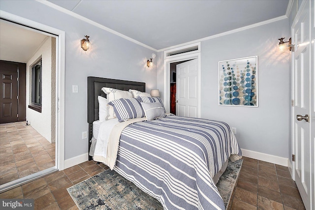 bedroom featuring crown molding, stone finish flooring, and baseboards