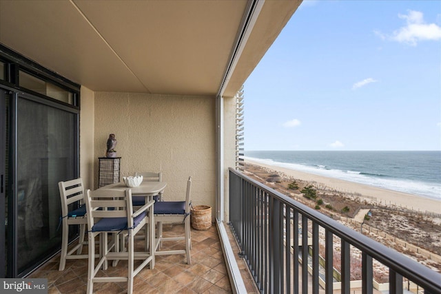 balcony featuring a water view and a view of the beach