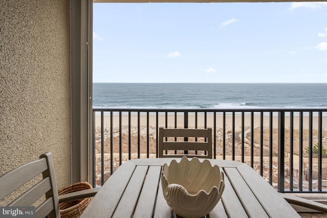 balcony with a view of the beach and a water view