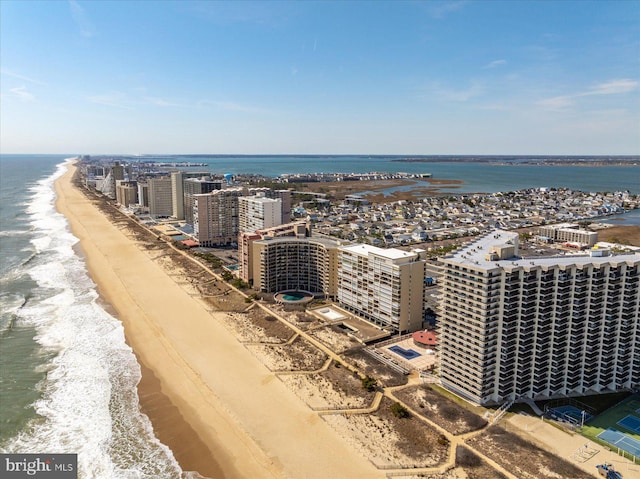 bird's eye view with a water view, a view of city, and a view of the beach