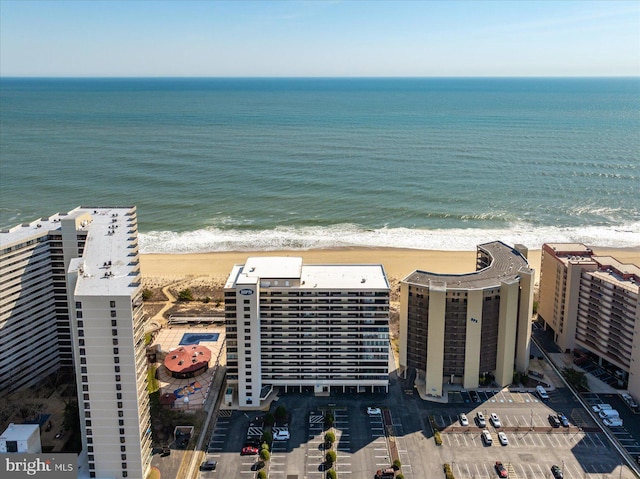 bird's eye view featuring a water view and a beach view