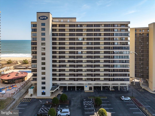 view of property with a view of the beach and a water view